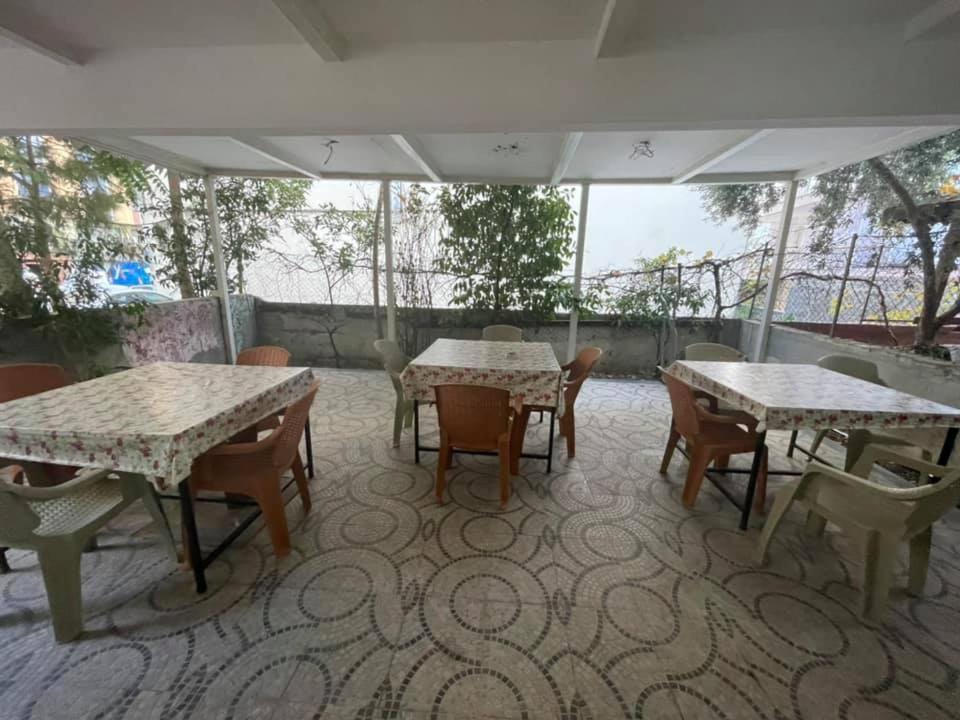 安塔利亚Özgür Hotel的户外庭院配有桌椅。