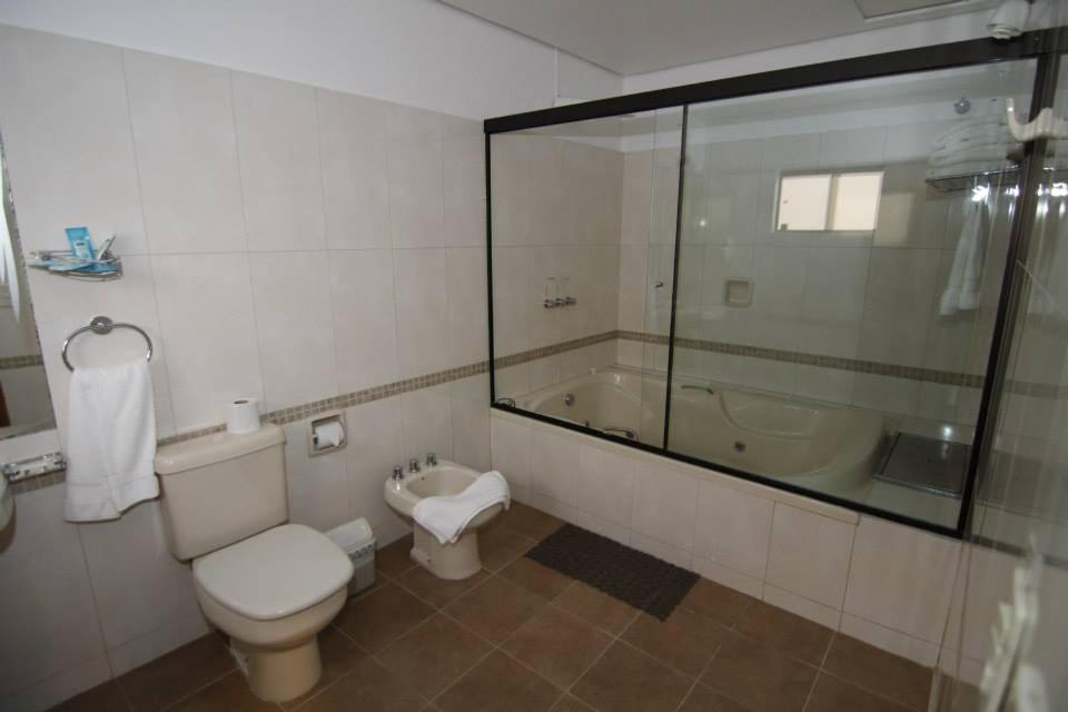 亚松森SBS Hotel & Spa的浴室配有卫生间、盥洗盆和浴缸。