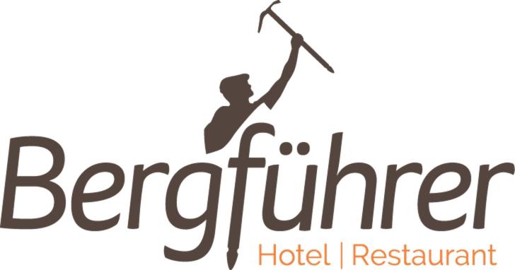 埃尔姆Hotel Bergführer的带有长矛的男子的酒店餐厅的标志