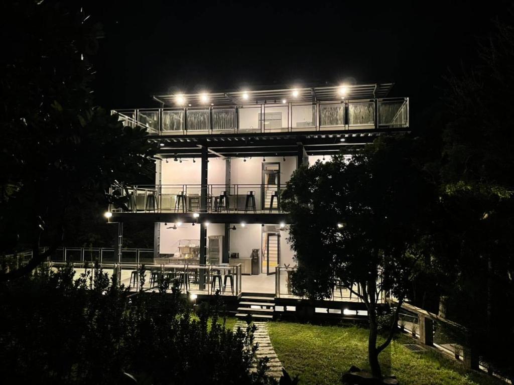 乌来乌来足立司拉别馆 - 梯田背包温泉旅店的一座带灯光甲板的建筑