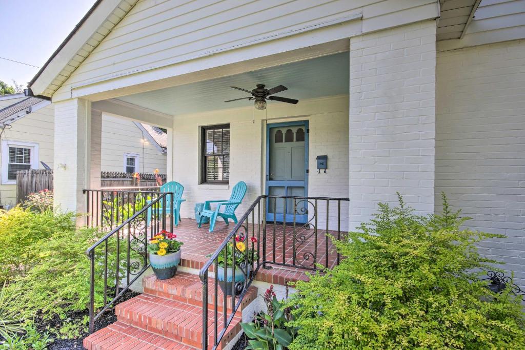 奥古斯塔Historic Augusta Cottage with Mid Century Vibe!的房屋设有门廊、两把椅子和风扇