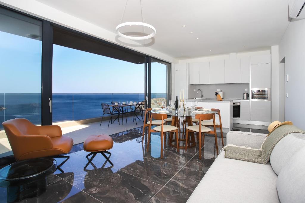 杜布罗夫尼克New&Luxury Apartment with an Outstanding View - Bombii Blue的厨房以及带桌椅的起居室。