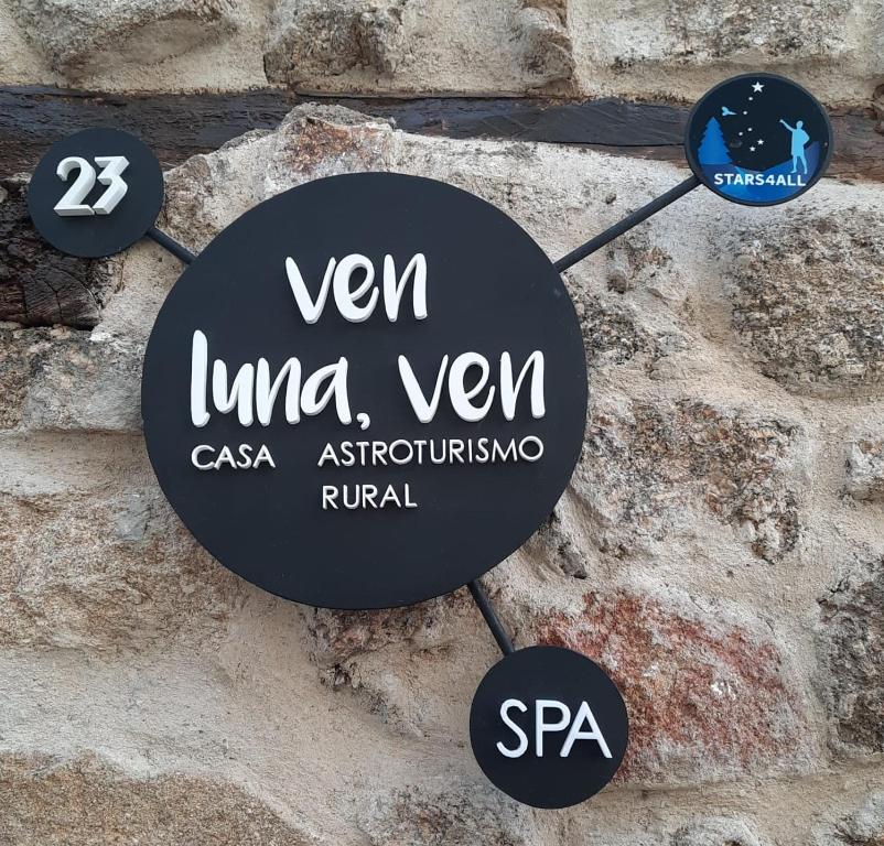 Casas del CastañarVEN LUNA, VEN Casa-SPA Astroturismo rural TR-CC-00361的石墙上的钟表,用词 ven ima yuan