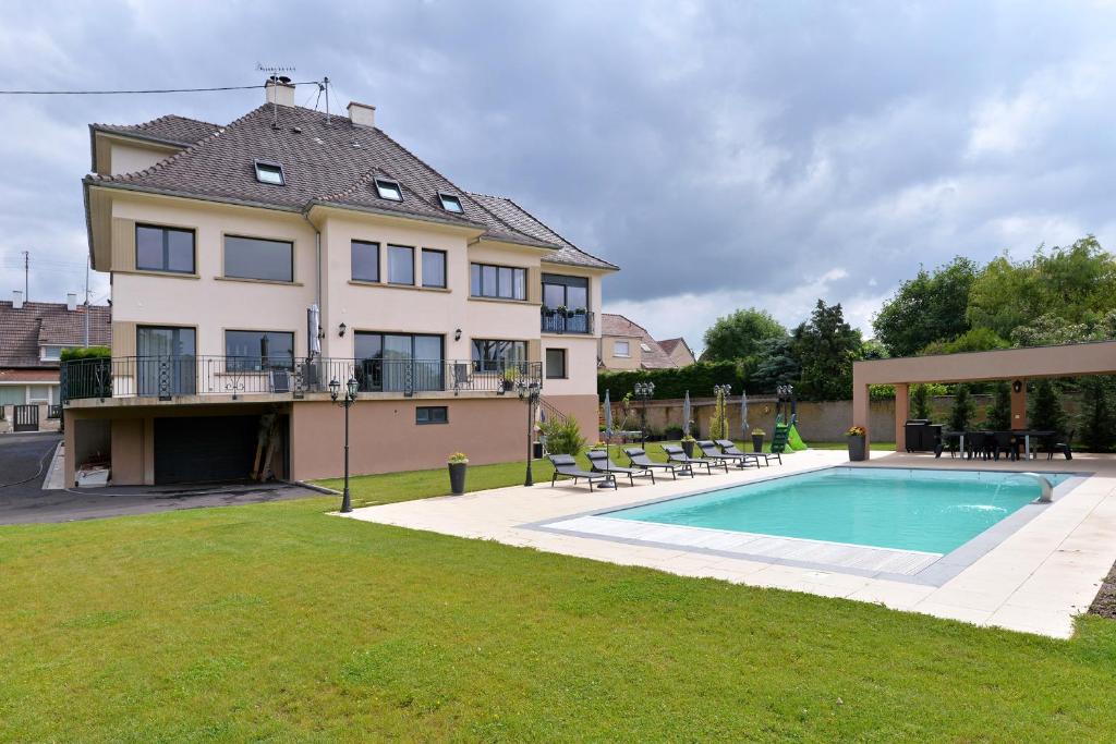 鲁法克Chambres Vignes et Châteaux的一座大房子,在庭院里设有一个游泳池