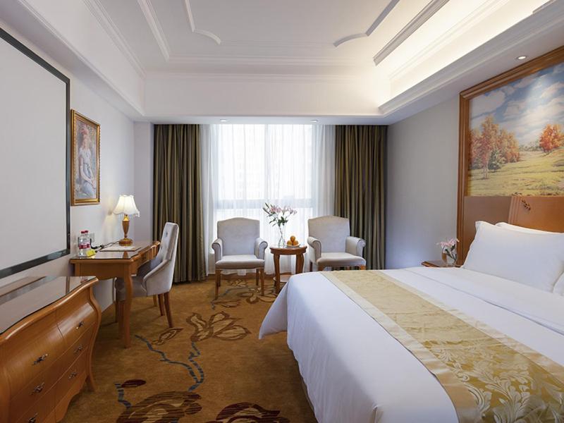 长沙维也纳国际酒店长沙树木岭城铁站店的酒店客房设有一张大床和一张书桌。