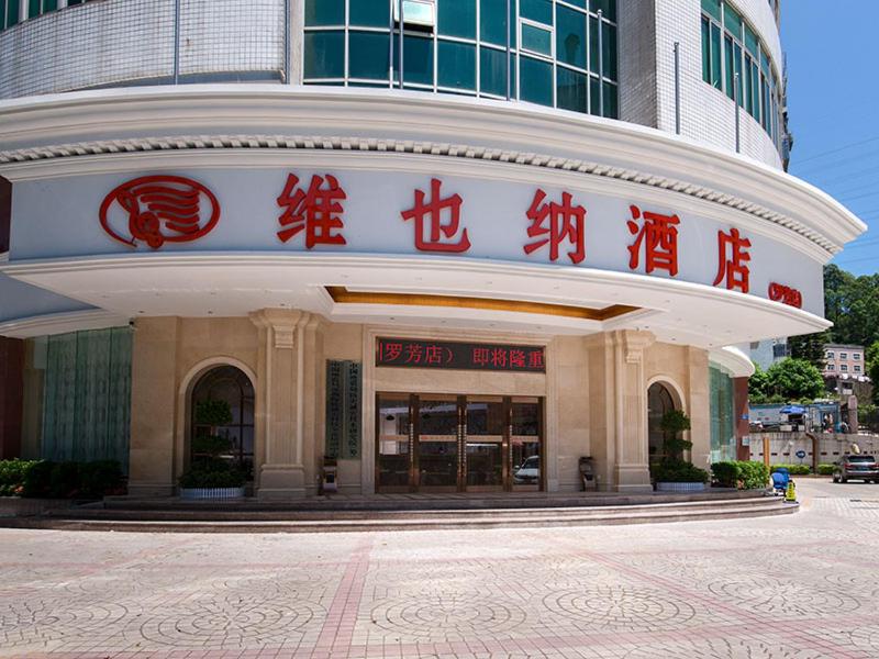 深圳维也纳酒店深圳罗芳店的前面有红色文字的建筑