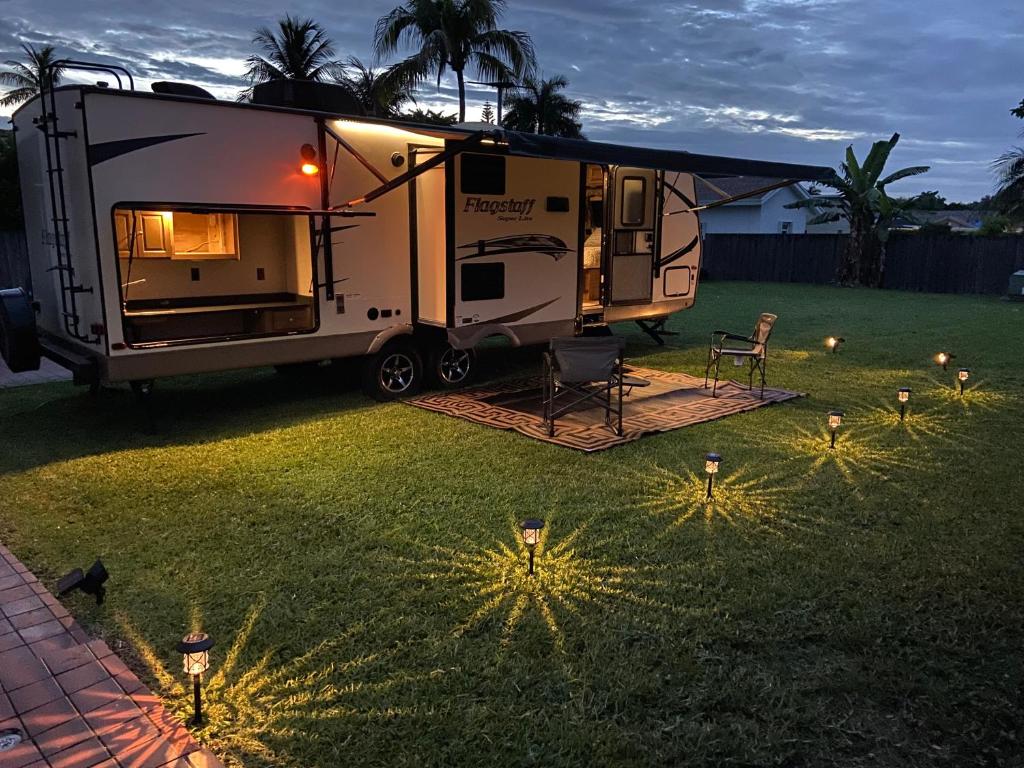 迈阿密Cozy Camper的停在院子里的 ⁇ ,在草地上放着灯光
