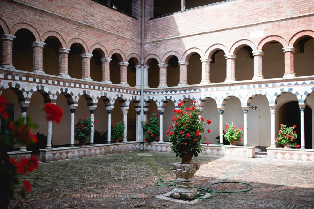 索维奇勒Antico Borgo di Torri的一座庭院,在建筑里种着红色的花