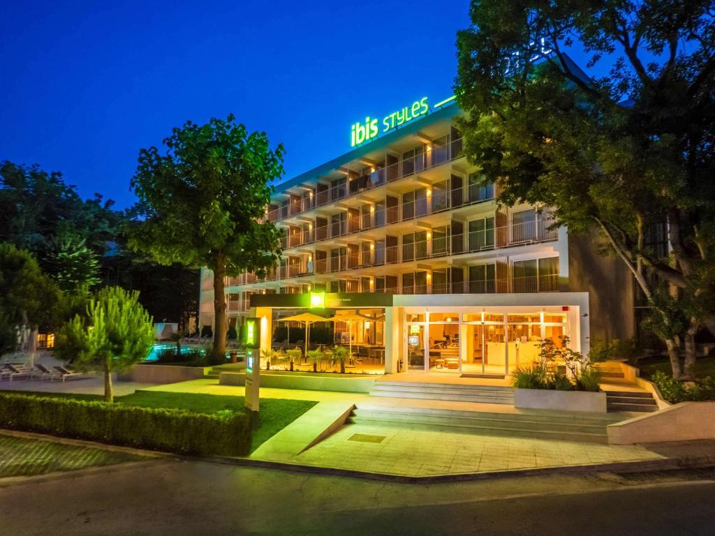 金沙ibis Styles Golden Sands Roomer Hotel的夜间有灯的旅馆
