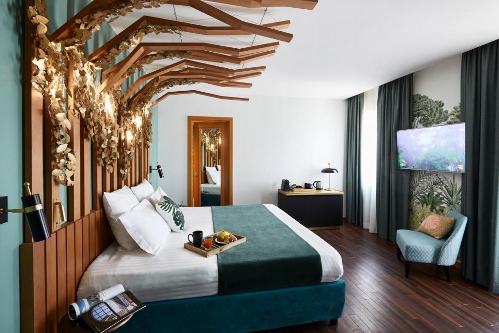 罗马罗马科索里亚斯特美居酒店的酒店客房的天花板上设有一张树床。