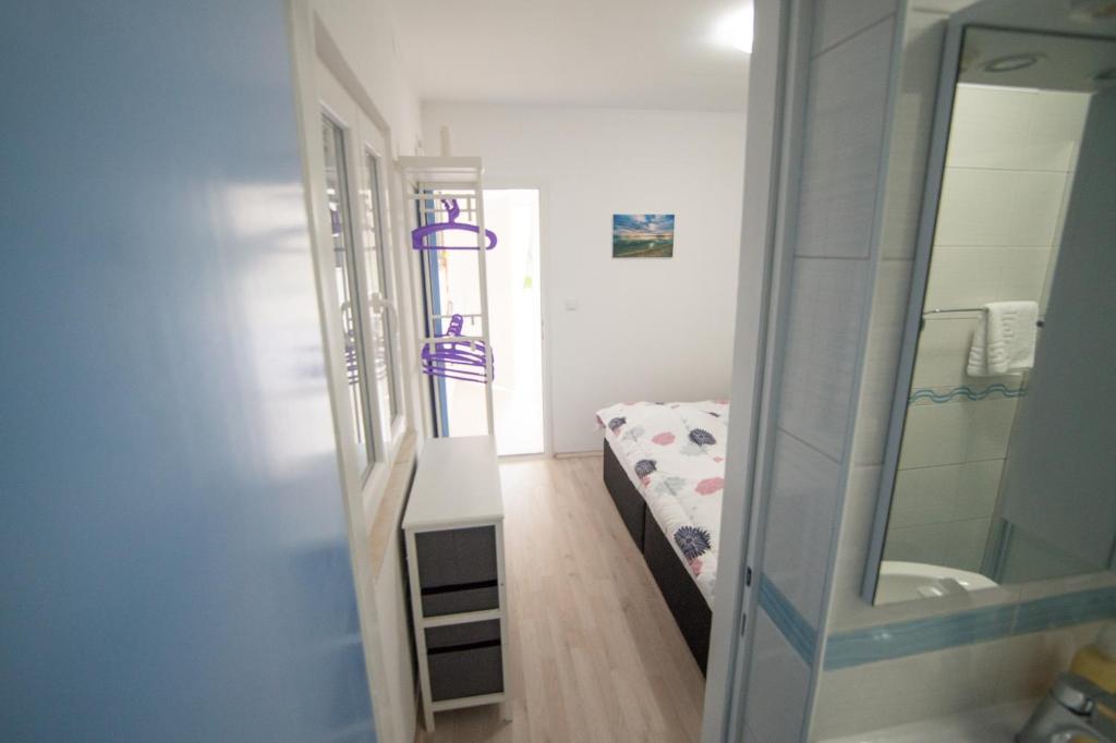 杜布罗夫尼克Apartment SunSet Dubrovnik FREE PARKING & WIFI的小房间设有床和镜子