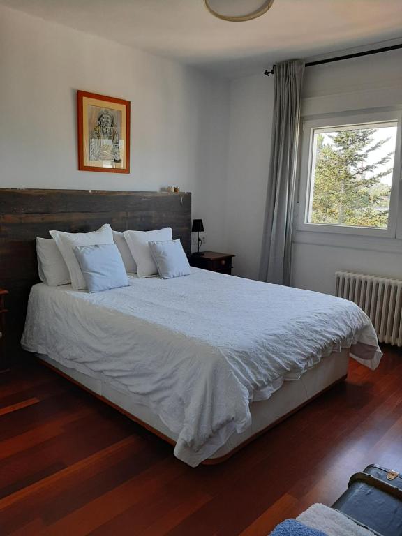 庞特维德拉Villa Anselma, casa compartida的卧室配有一张带白色床单的大床和窗户。