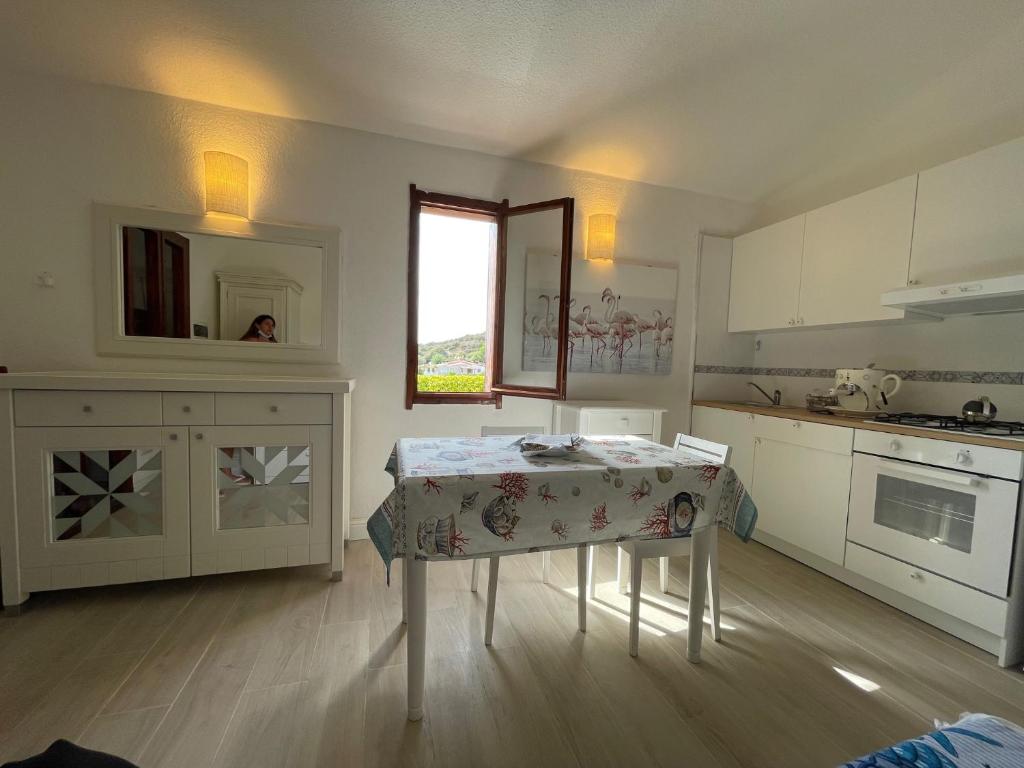 杰若米斯Villetta Azzurra Kal'è Moru的白色的厨房,配有桌子和窗户