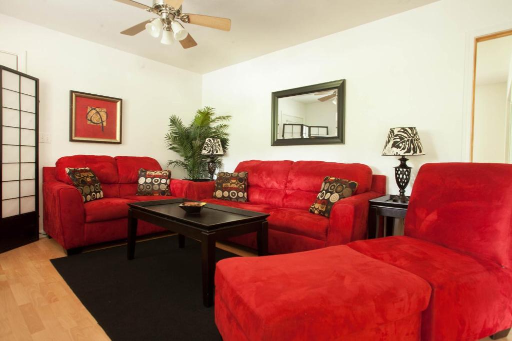 沃尔卡诺欧哈那第五街酒店的客厅配有红色的沙发和桌子