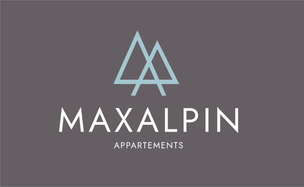 朗根费尔德MAXAlpin Appartements的印有缩写字 ⁇ 的制造公司的标志