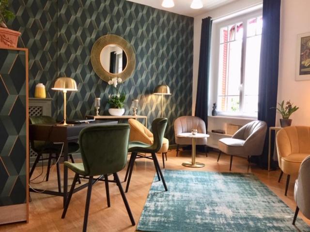 南特Hôtel Coeur De Loire的客厅配有桌椅和镜子