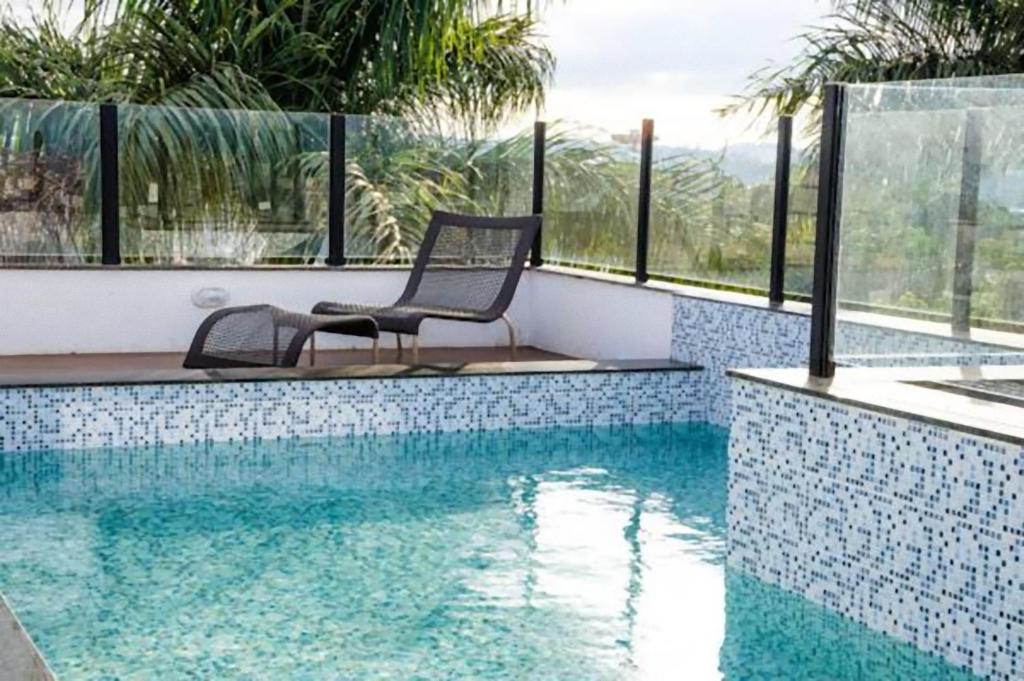 贝洛奥里藏特潘普利亚斯托普优质酒店的游泳池旁的椅子