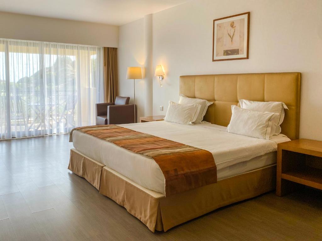 阿尔沃尔Foz Club - Algarve的一间位于酒店客房内的带大床的卧室
