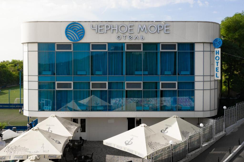 敖德萨奥特拉达黑海酒店的前面有一把遮阳伞的大型办公楼