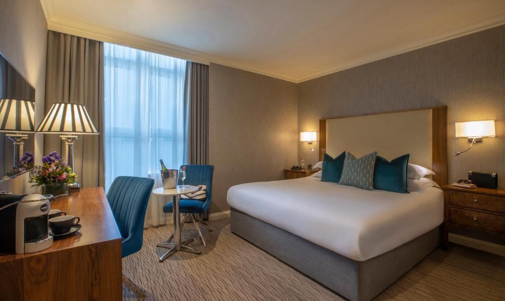 戈尔韦维多利亚酒店的配有一张床和一张书桌的酒店客房