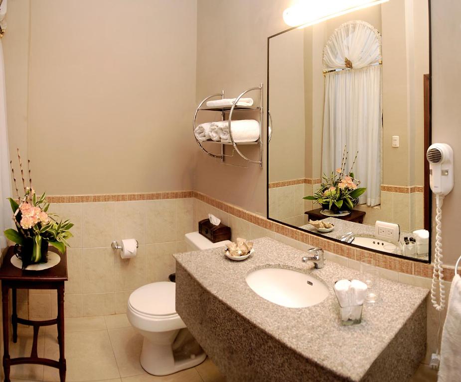 瓜亚基尔德尔里奥精品酒店的一间带水槽、卫生间和镜子的浴室