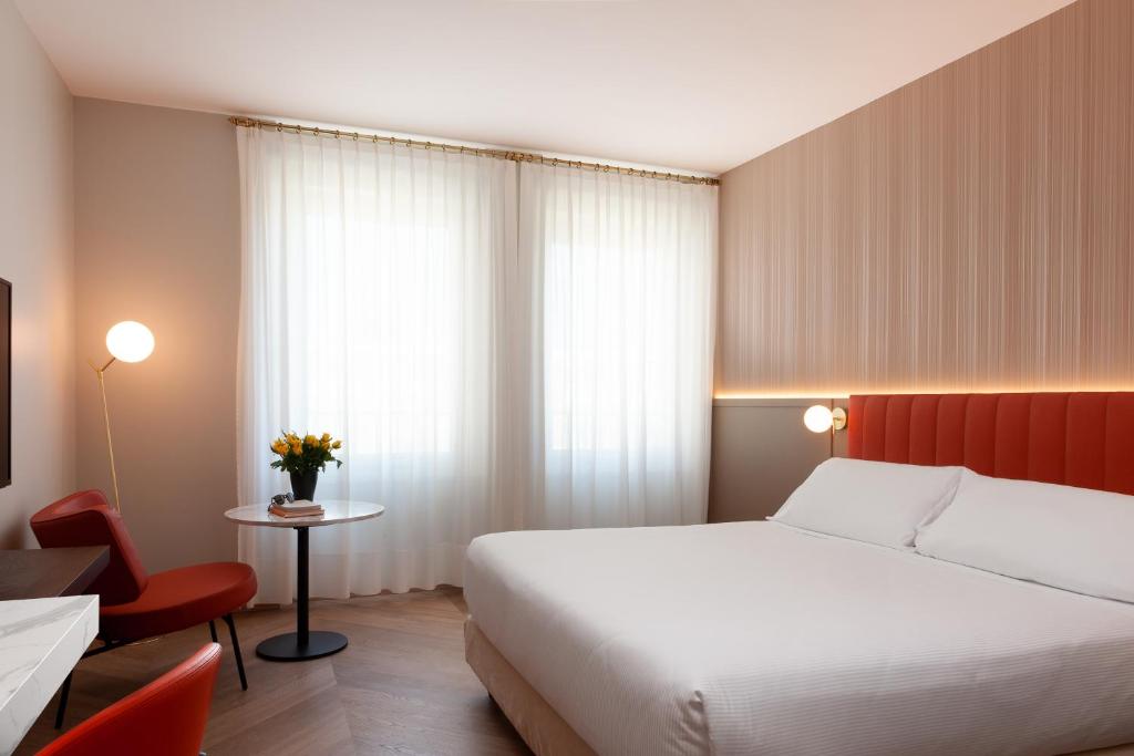 比耶拉阿戈拉皇宫酒店的酒店客房,配有床、桌子和椅子