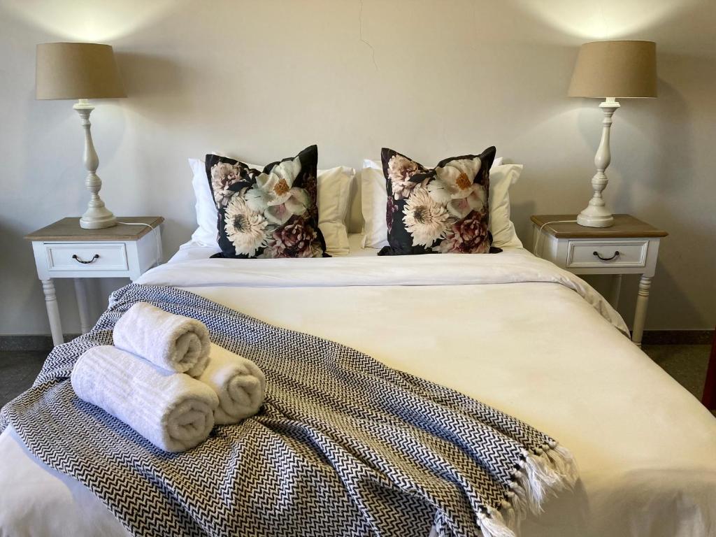 布隆方丹Tidor Garden Cottage的一间卧室配有带毛巾的床