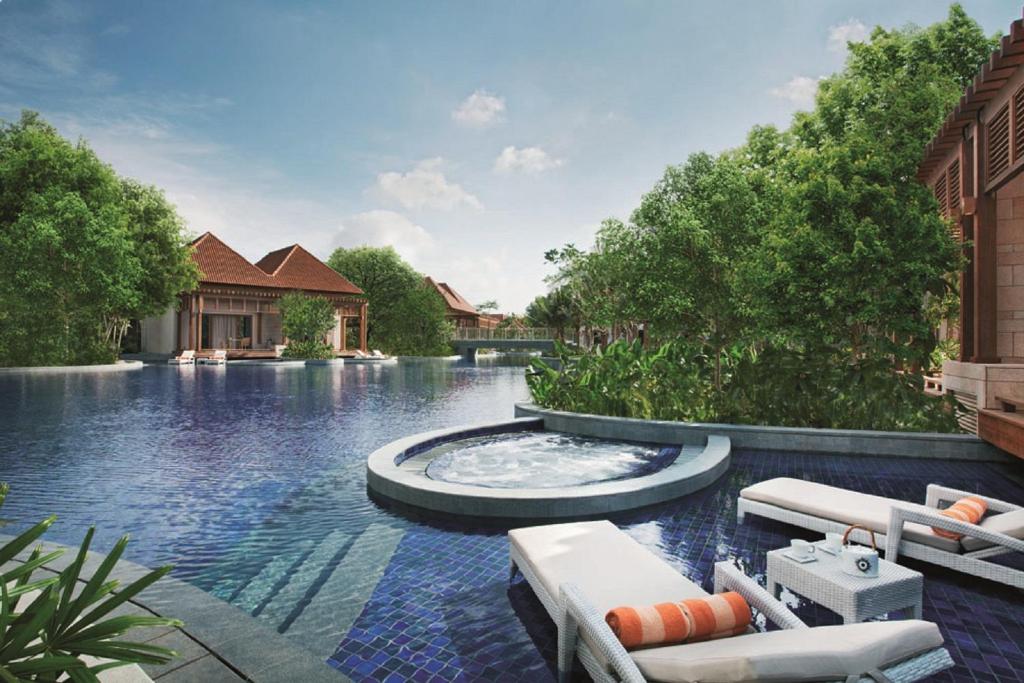 新加坡Resorts World Sentosa - Equarius Villas的一座房子中间带喷泉的游泳池