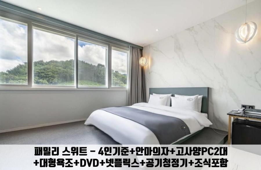 金海市Gimhae Jangyu Stayin Hotel的一间卧室设有一张床和一个大窗户