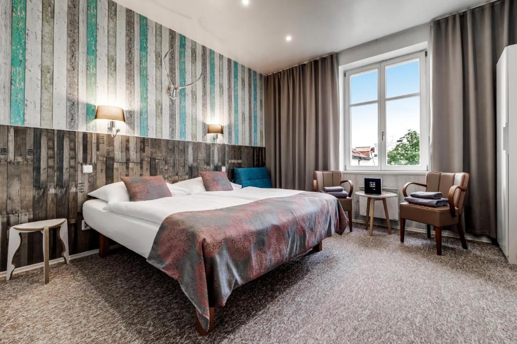 布拉格康特皇家酒店的酒店客房带一张大床和一把椅子