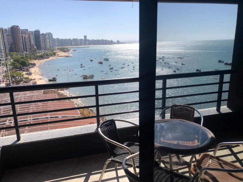福塔莱萨Iate Plaza Beiramar Fortaleza app1006的一个带椅子的阳台,享有海滩美景