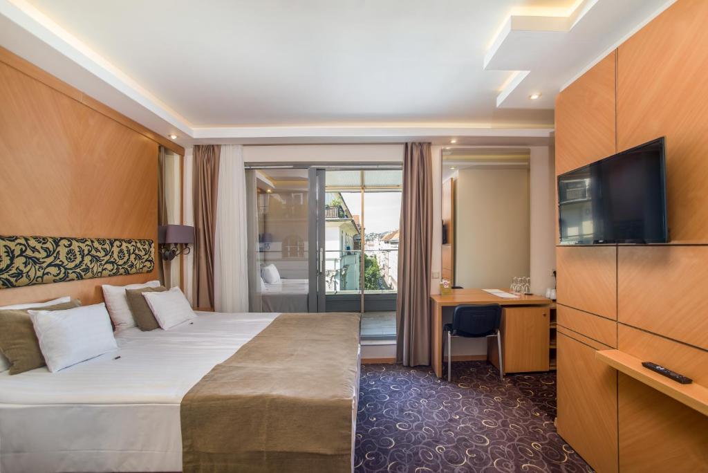 布达佩斯布达佩斯玛拉玛拉酒店的酒店客房,配有床和电视