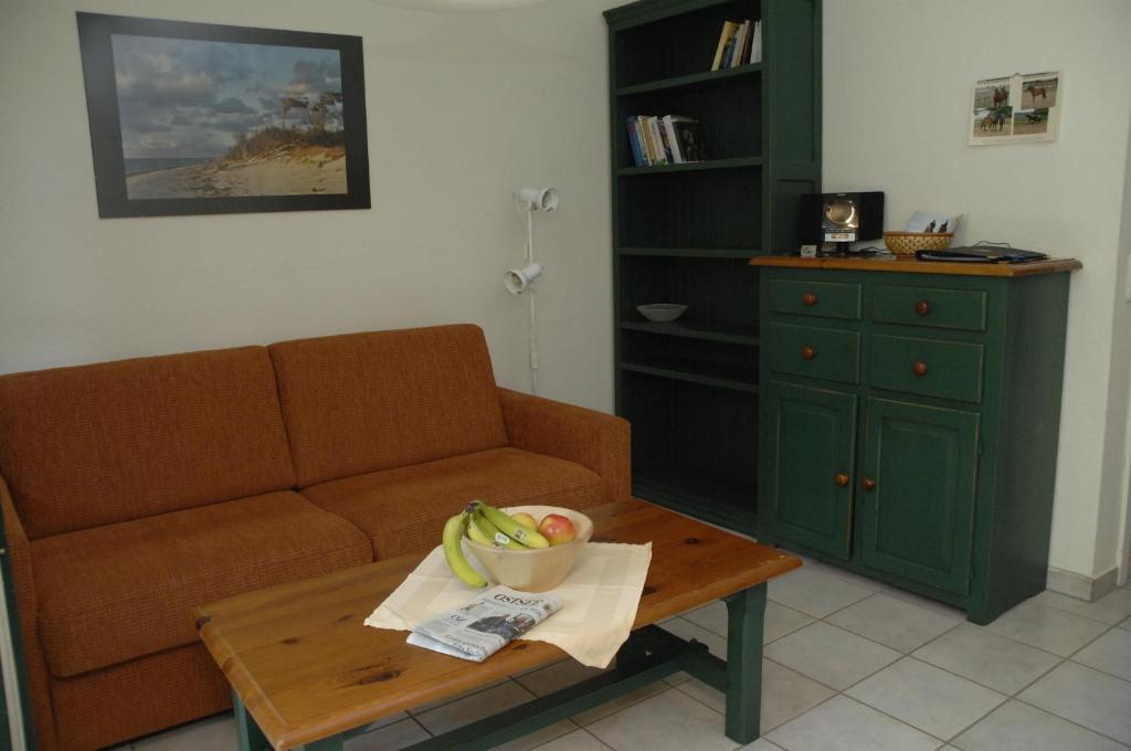 Neu KlockenhagenMaisonette-Ferienwohnung "Trakehnen"的客厅配有沙发和带一碗香蕉的桌子