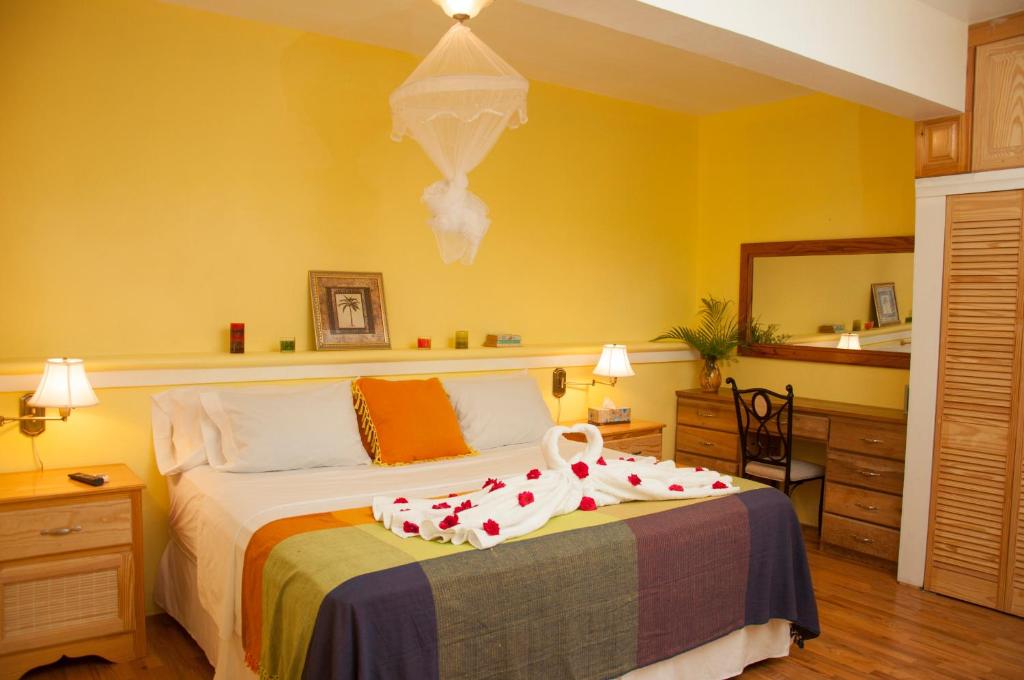 罗索钻石怡景别墅酒店的一间卧室配有一张带白色床罩的床