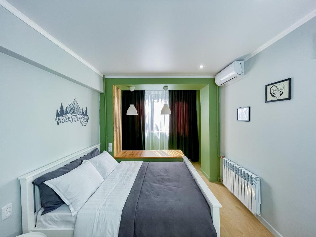 阿拉木图Evergreen Apart的绿色和白色客房的一张床位