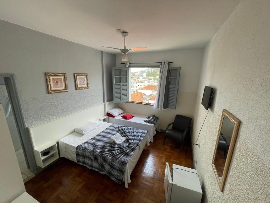 尤西德福拉Hotel Centenário的小房间设有床和窗户