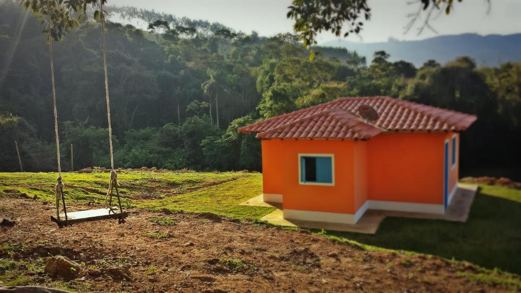 索科罗Fortuna Casas de Campo的田野上的橙色房子,带秋千