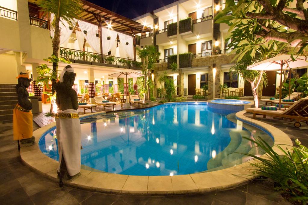 库塔芒加尔印尼酒店的酒店游泳池旁边设有2人