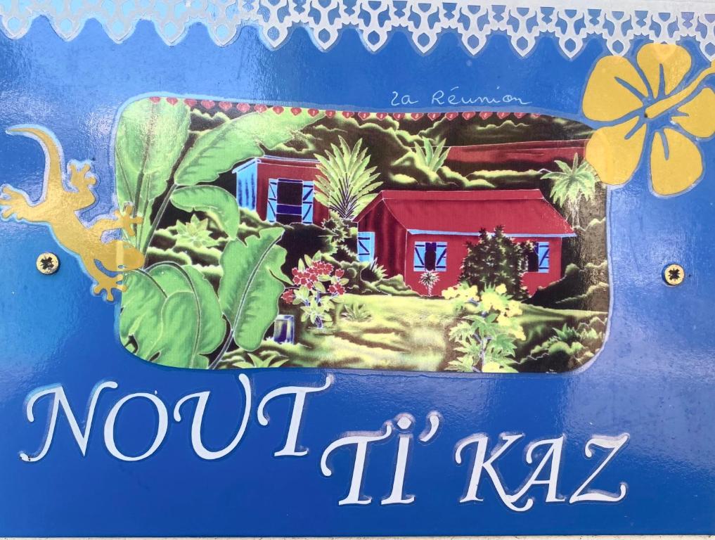 埃唐萨莱莱班海滩NOUT TI KAZ lé bains的带有房屋和植物照片的标志
