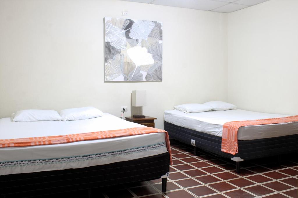 圣安娜Casa Central de Santa Ana的两张睡床彼此相邻,位于一个房间里