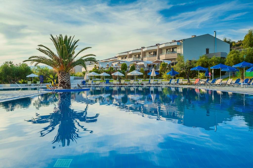 尼尔斯吉尼恩诺斯安塔赛Spa度假酒店的一个带椅子和遮阳伞的大型游泳池