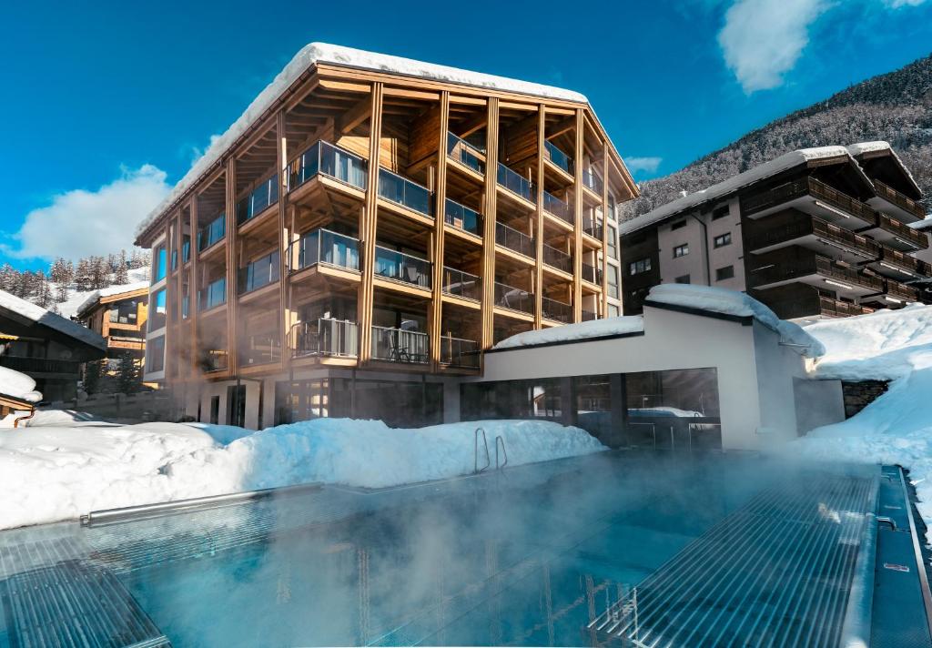 采尔马特Resort La Ginabelle的雪中带游泳池的酒店