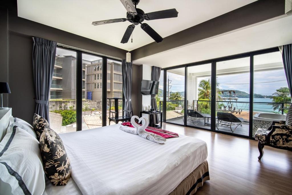 芭东海滩See Sea Villa Phuket SHA的一间卧室设有一张大床和一个大窗户