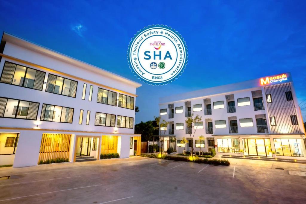 清莱Meesuk ChiangRai Hotel, SHA Certified的带有读取shka的标志的建筑