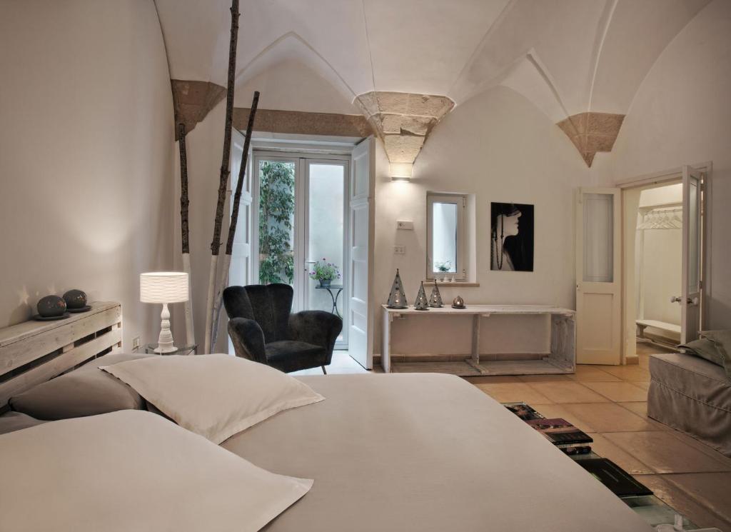 莱切Corte dei Romiti Apartment的一间带白色床的卧室和一间浴室