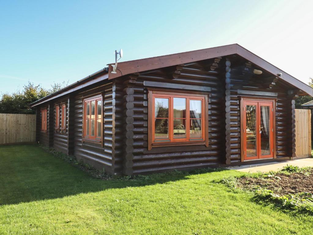 奥克姆Rowan Lodge的小木屋设有窗户和庭院