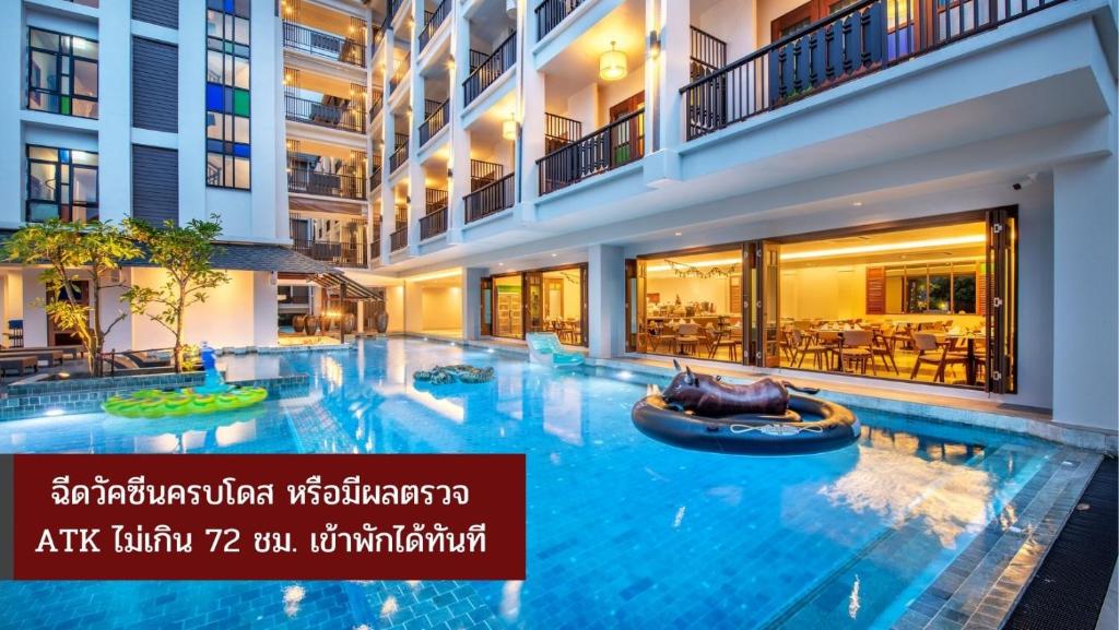 合艾Monkham Village Hat Yai的一座大型游泳池,位于酒店大楼内