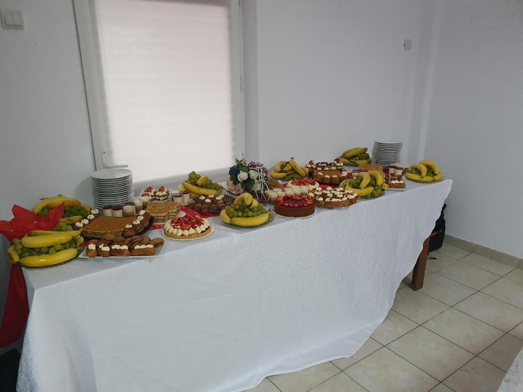 CîmpeniPENSIUNEA ANAIS的餐桌上放满了各种蛋糕和甜点