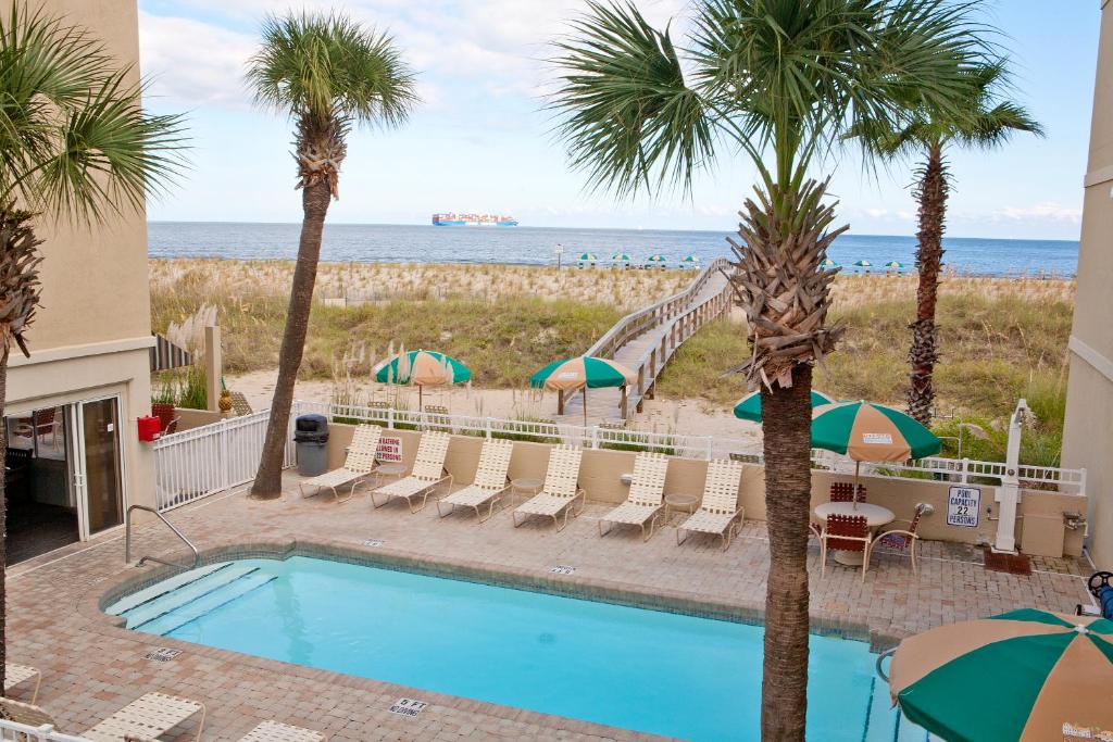 泰比岛德索托海滩酒店的一座棕榈树游泳池和滑梯