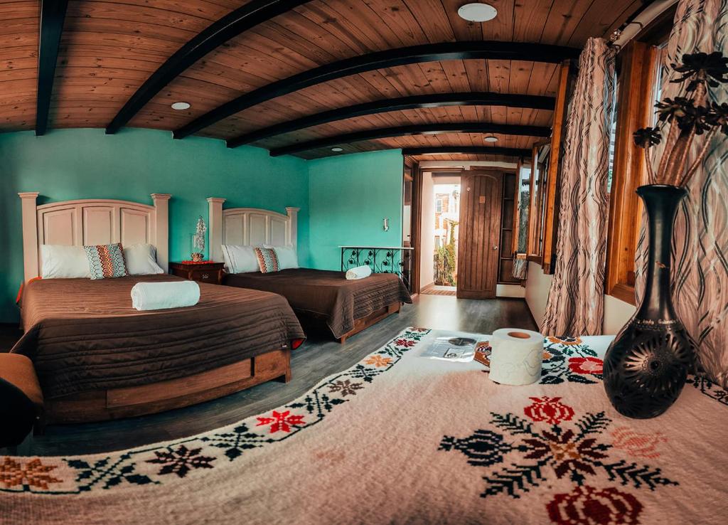 底拉斯卡拉Hostal Mago的一间设有两张床的卧室,位于带绿色墙壁的房间